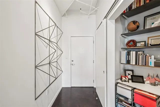 a view of an entryway with wooden shelves