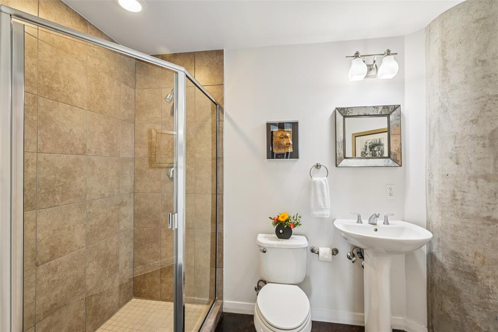 1001 Belleview Street, Unit 708 Dallas, TX 75215 - Photo 26 of 40 a bathroom with a sink toilet and shower