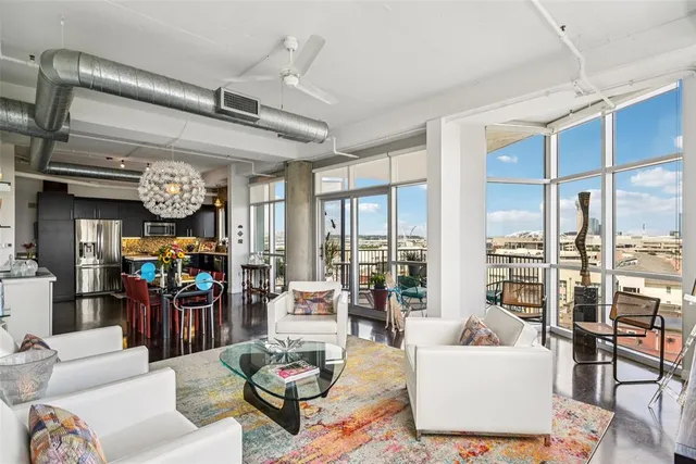 a living room with lots of furniture and chandelier