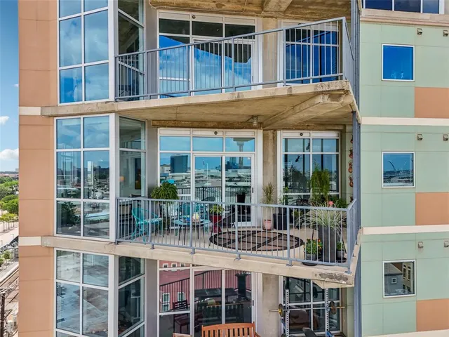 a roof deck with table and chairs