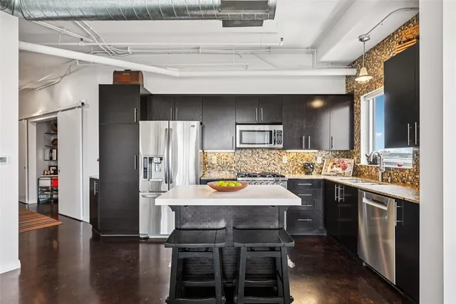a large kitchen with a table and chairs