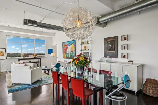 a group of people sitting in a kitchen and living room