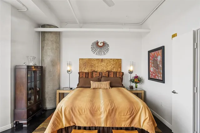 a bed sitting in a bedroom next to a window