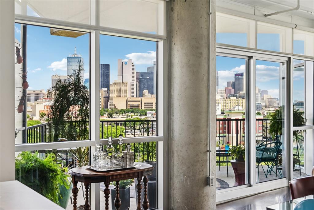 1001 Belleview Street, Unit 708 Dallas, TX 75215 - Photo 8 of 40 a view of a balcony with a floor to ceiling window and wooden floor