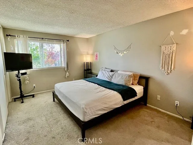 a bedroom with bed and window