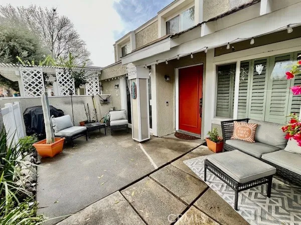 a view of a couches and table in backyard of the house