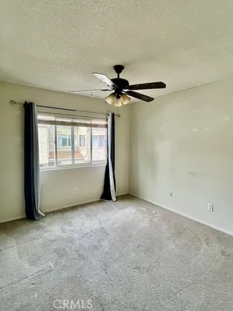 a view of a refrigerator with wooden cabinets