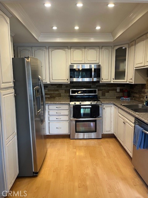 25729 Tournament Road Valencia, CA 91355 - Photo 6 of 31 a kitchen with stainless steel appliances a stove a microwave and a refrigerator