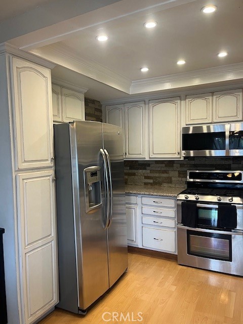 25729 Tournament Road Valencia, CA 91355 - Photo 7 of 31 a kitchen with stainless steel appliances granite countertop a refrigerator a stove and a sink