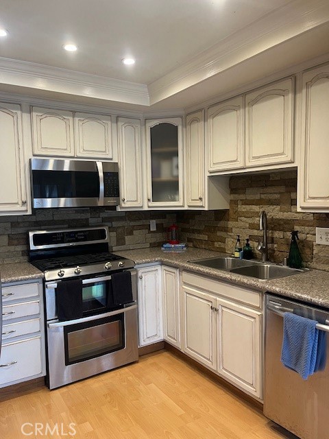 25729 Tournament Road Valencia, CA 91355 - Photo 8 of 31 a kitchen with sink a microwave and cabinets