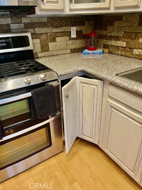 25729 Tournament Road Valencia, CA 91355 - Photo 9 of 31 a kitchen with stainless steel appliances granite countertop a stove and a microwave