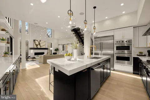 a kitchen with stainless steel appliances kitchen island a large island in the center