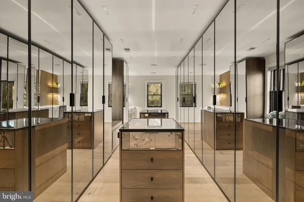 a view of a hallway with dining table and chairs