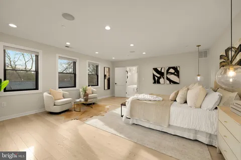 a living room with furniture and large windows