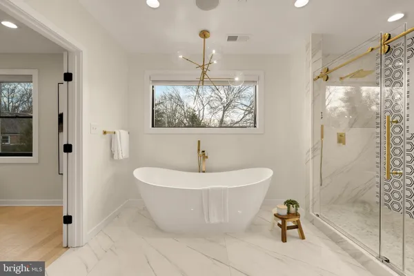 a white bath tub sitting next to a white sink