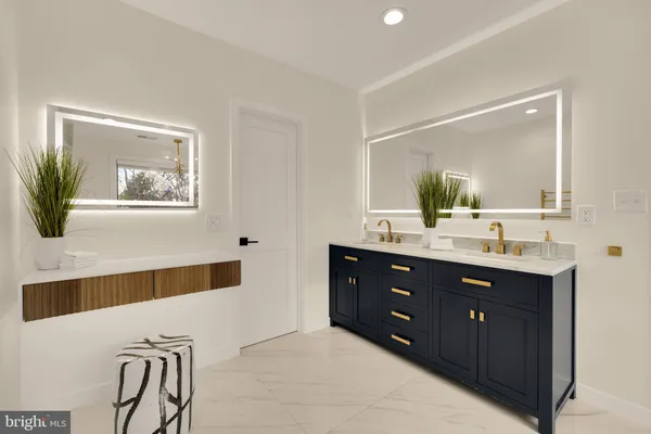 a bathroom with a double vanity sink a mirror and a bathtub