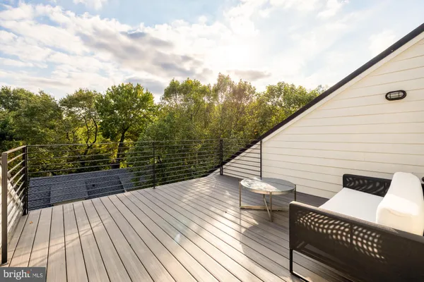 a view of balcony with wooden floor and fence
