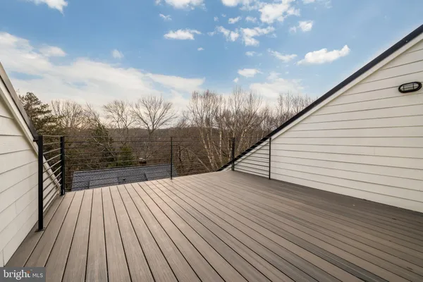 a view of balcony with wooden floor and fence