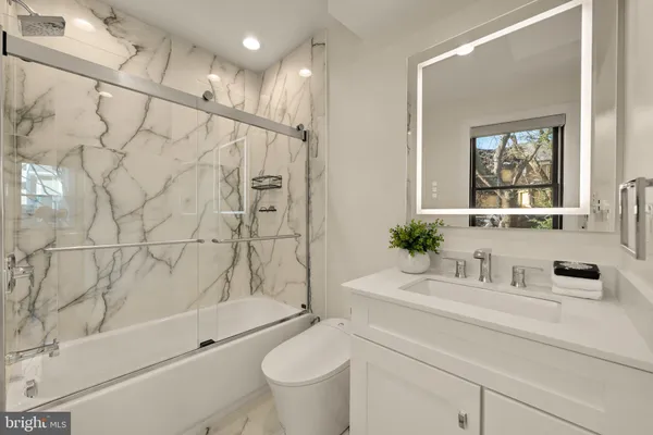 a bathroom with a sink a toilet and a bathtub