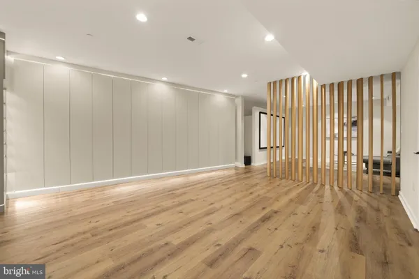 a view of an empty room with wooden floor