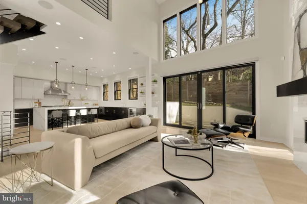 a living room with furniture a floor to ceiling window and a flat screen tv