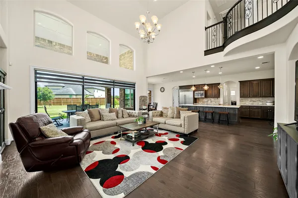 a living room with furniture fireplace and a large window