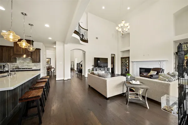 a view of a dining room with furniture a fireplace and chandelier