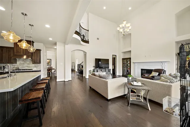 a view of a dining room with furniture a fireplace and chandelier