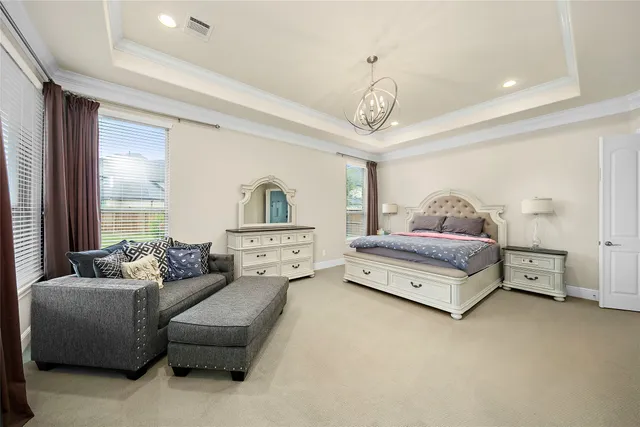 a spacious bedroom with a bed and window