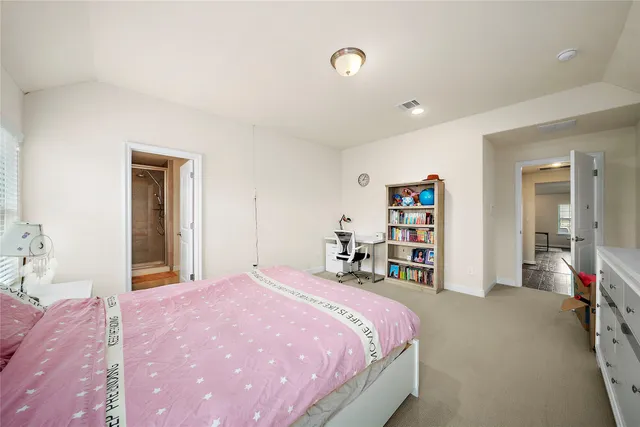 a bedroom with a bed and a large mirror