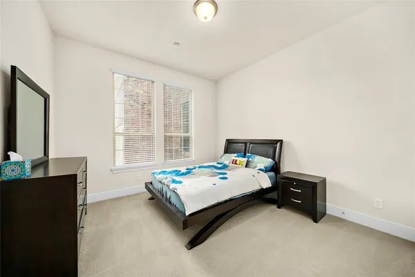 a bedroom with bed and a window