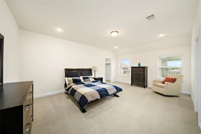 a bedroom with bed and furniture