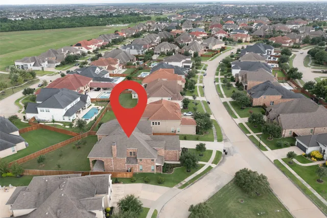 an aerial view of residential houses with outdoor space