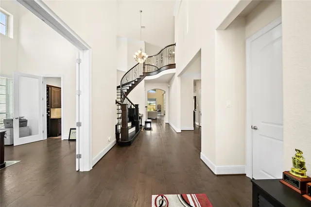 a view of a livingroom with wooden floor and stairs