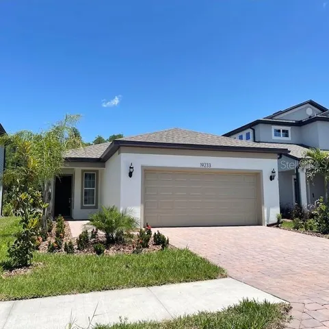 a front view of a house with a yard and garage