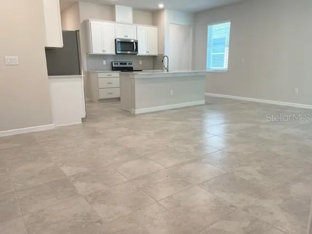 a view of a kitchen with a microwave and cabinets