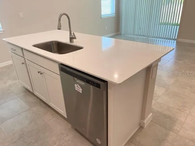 a kitchen with a sink and cabinets