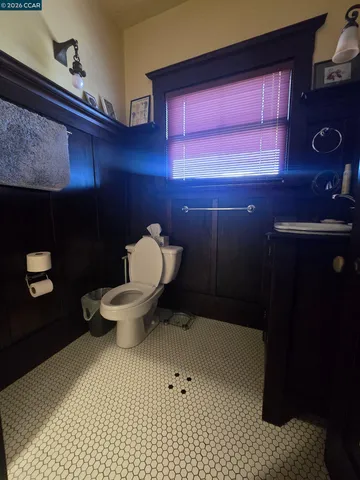 a bathroom with a toilet a sink and mirror