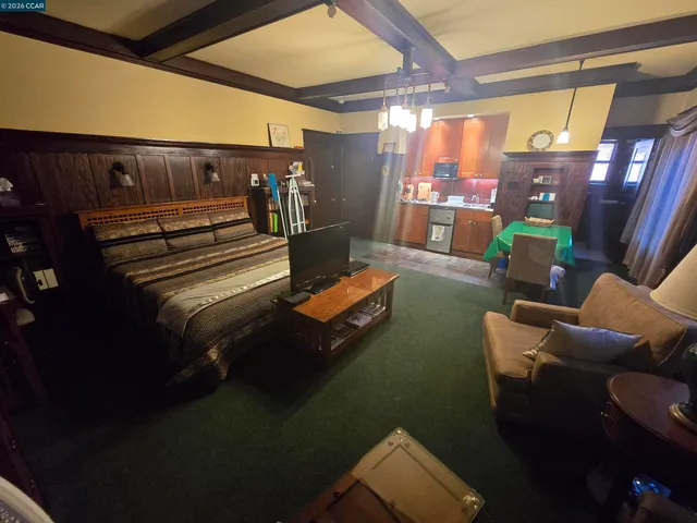 a living room with furniture and a floor to ceiling window