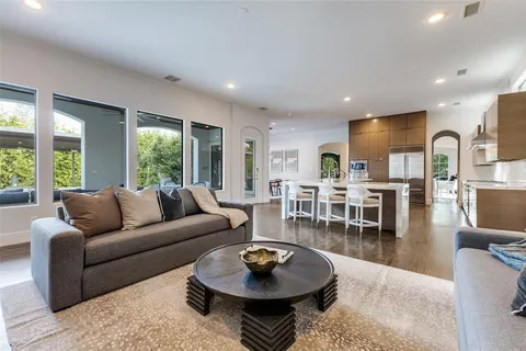 a living room with furniture a dining table and a large window
