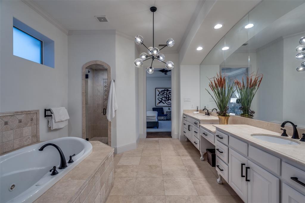 8647 Wingate Drive Dallas, TX 75209 - Photo 17 of 27 a bathroom with a double vanity sink a tub and a mirror