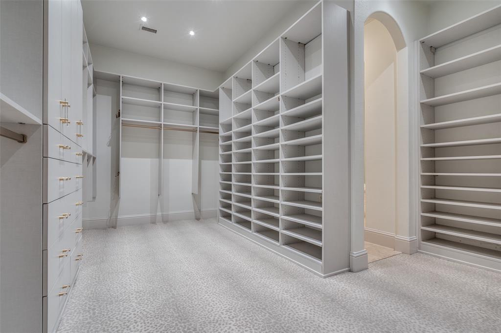 8647 Wingate Drive Dallas, TX 75209 - Photo 18 of 27 a view of an empty room with a white cabinet and a window