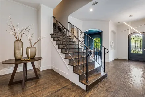 a view of entryway with wooden floor and stairs