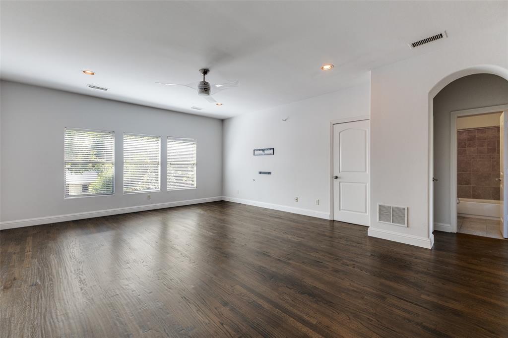 8647 Wingate Drive Dallas, TX 75209 - Photo 21 of 27 an empty room with wooden floor and windows