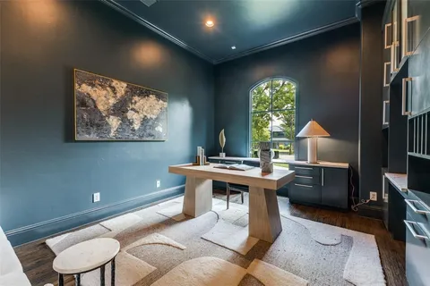 a room with furniture a window and a painting on the wall