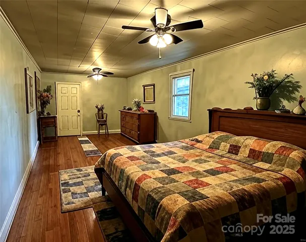 a bed sitting in a bedroom and a chandelier