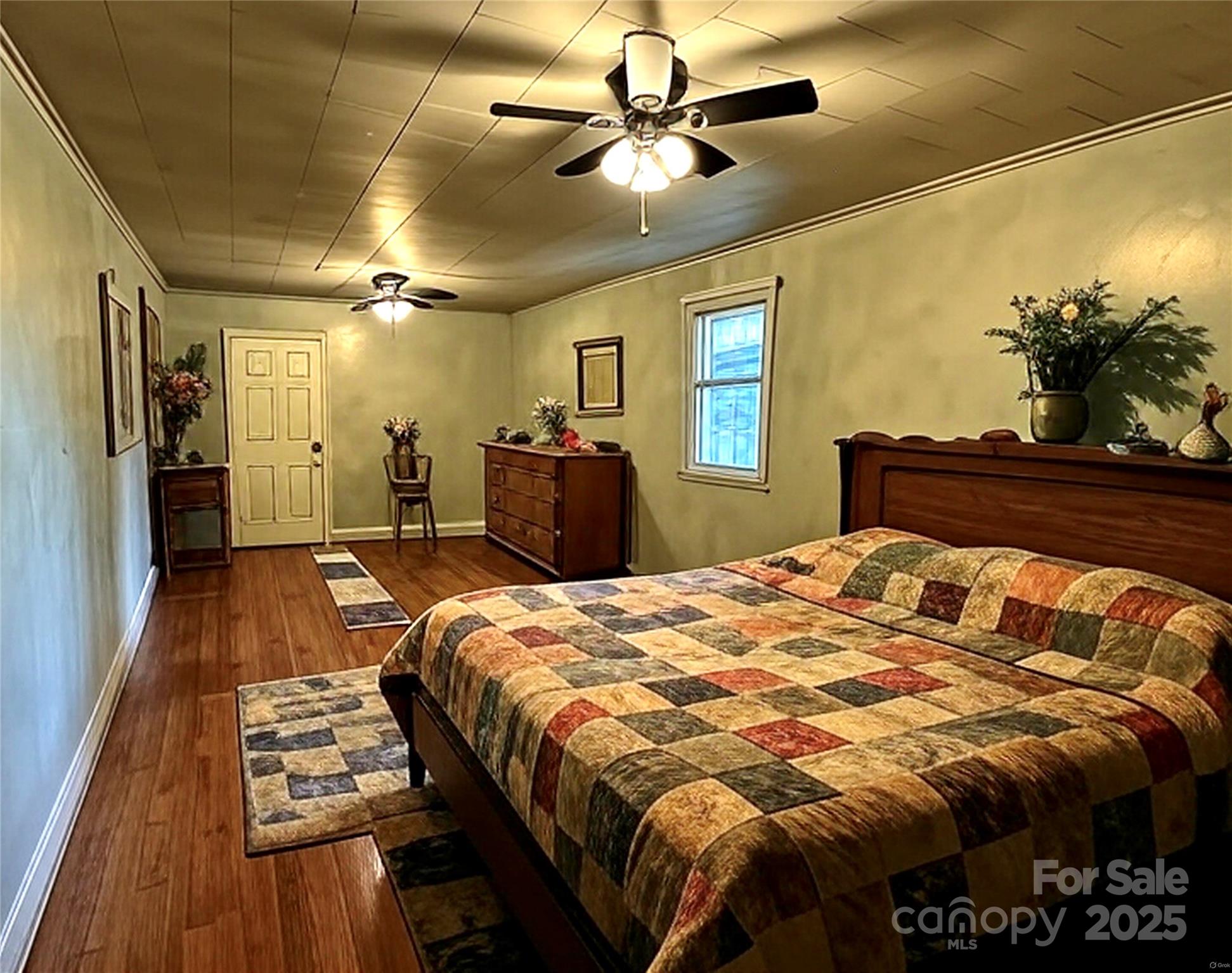 208 Murdock Road Bakersville, NC 28705 - Photo 14 of 32 a bed sitting in a bedroom and a chandelier