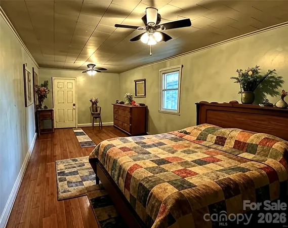 a bed sitting in a bedroom and a chandelier