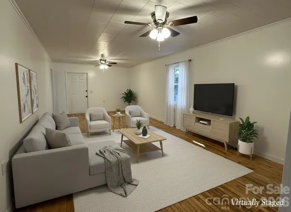 a living room with furniture and a flat screen tv