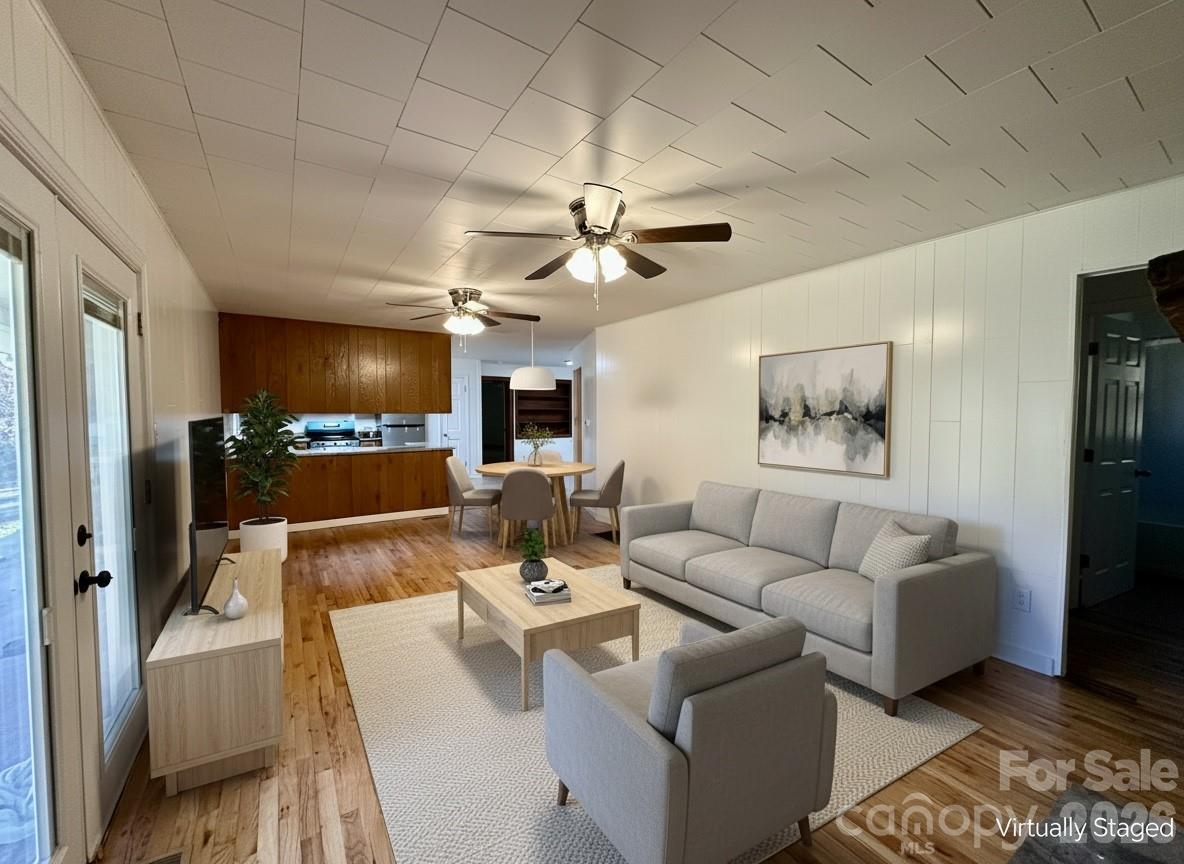 208 Murdock Road Bakersville, NC 28705 - Photo 16 of 46 a living room with furniture a fireplace and a chandelier